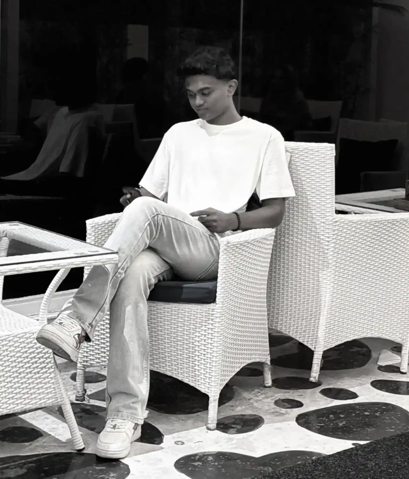 Best Freelance Digital Marketer In Malappuram Sitting In a Chair Looking At The Phone